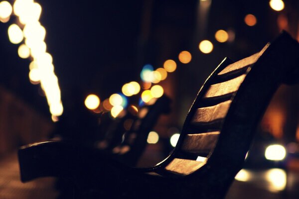 Bench in the night city on the background of lights