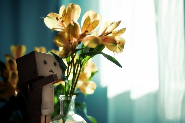 Homemade flowers and a cardboard man in a sunny room