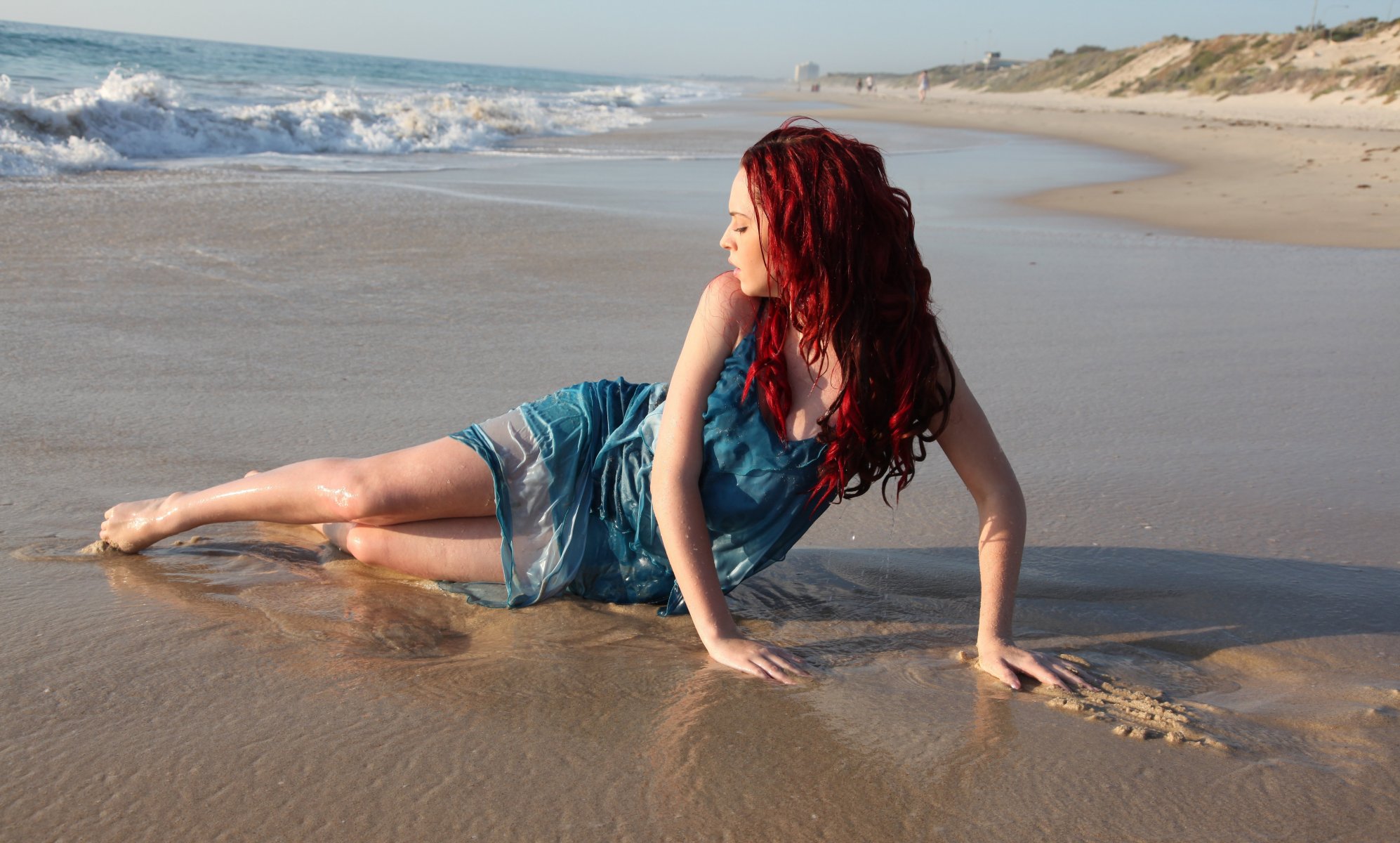 girl red hair pose section sand beach sea wave