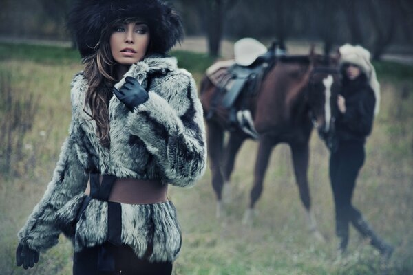 A girl with a horse in winter clothes