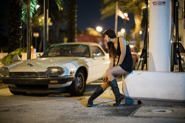 Street scene with a car and a girl in high boots