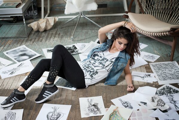 The model girl is lying on the floor