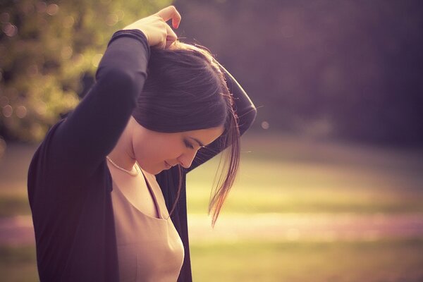 Brunette girl braids her hair