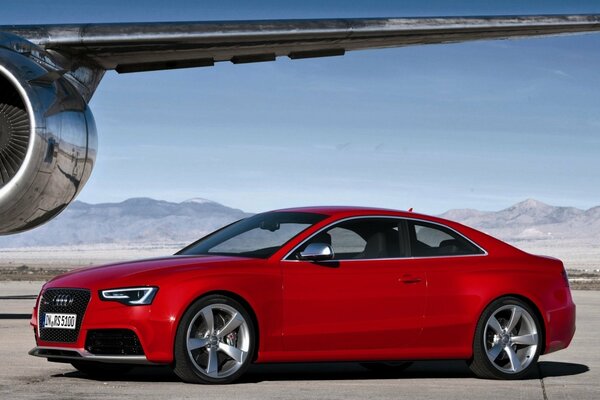 Red Audi Coupe shaped like an airplane