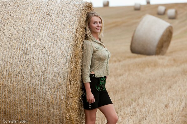 Blonde girl with a haystack