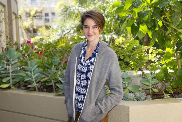 Portrait of a girl on a background of greenery