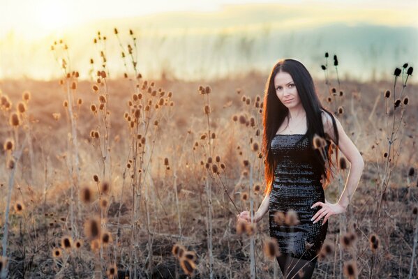 Brunette girl in black in the grass