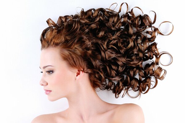 A girl with a curly hairstyle on a white background