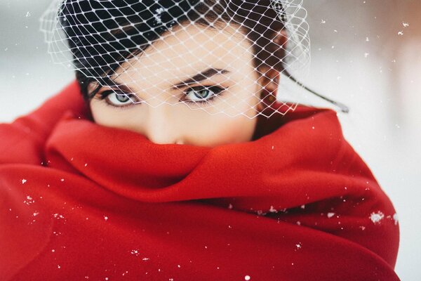 A girl in red with a piercing gaze winter