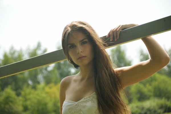 A girl with long hair is holding onto a crossbar