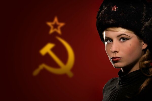 Russian girl on the background of the USSR flag