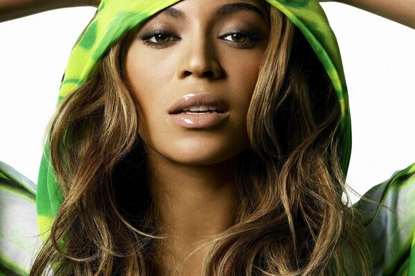 Beyonce poses in a green hood