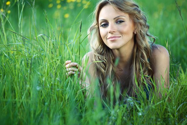 Photo of a girl in the summer in the grass