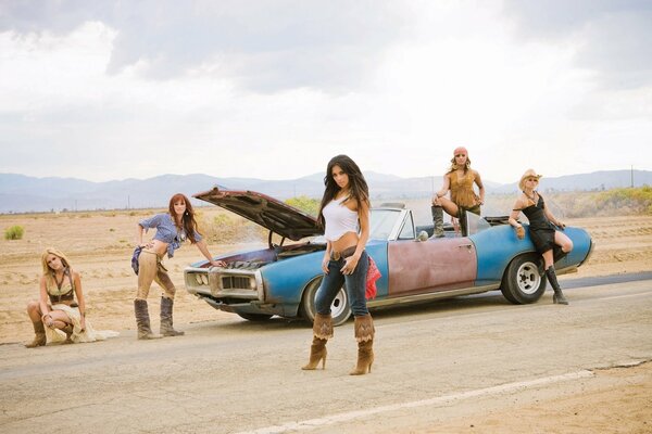 Girls in boots on a desert background