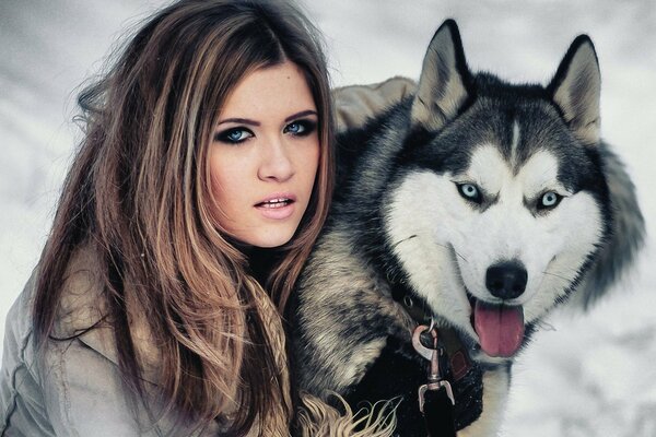 Girl and husky with blue eyes