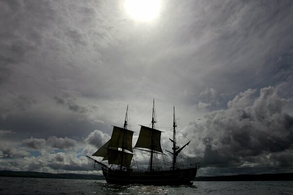 A ship against a background of dark clouds