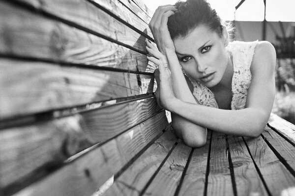 Black and white painting of a girl on a bench