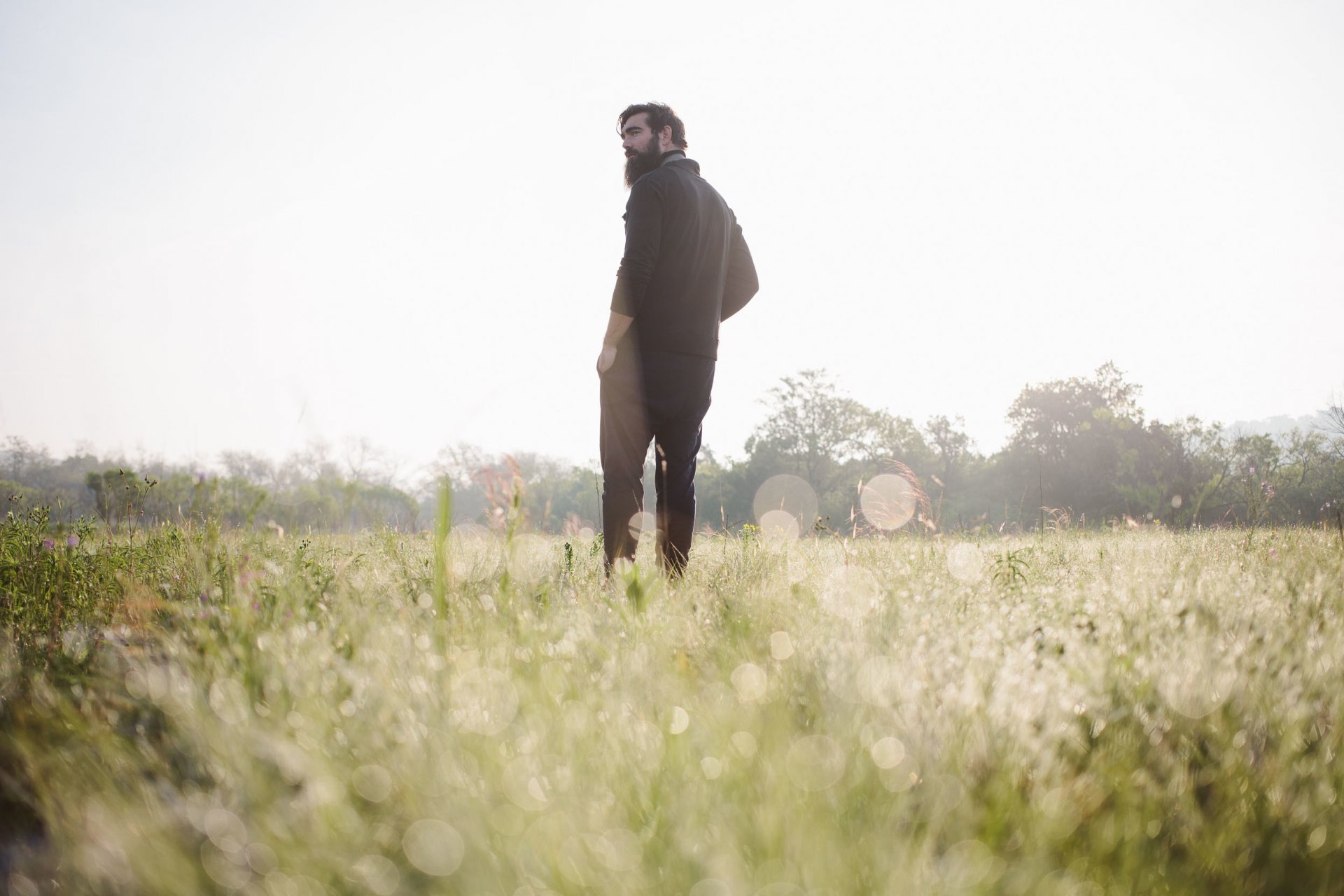 homme dos à la recherche champ herbe forêt ciel ensoleillé