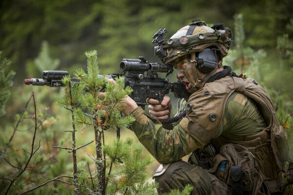 A Norwegian army soldier holds a gun