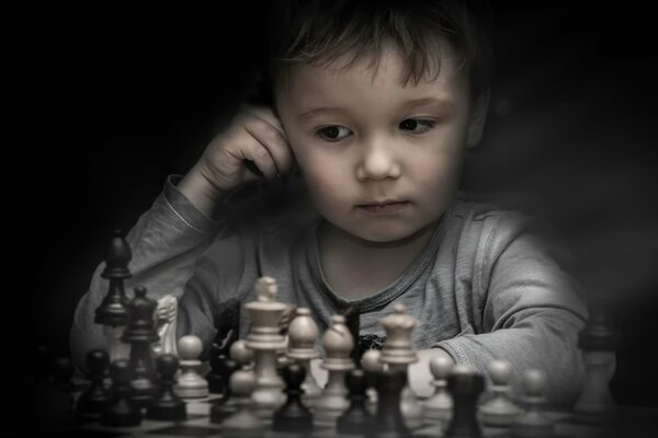 Petit garçon jouant aux échecs