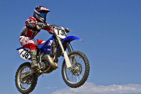 A motorcyclist in the air at a sports race