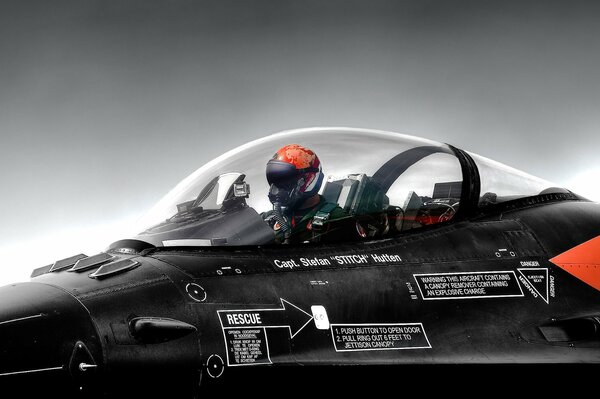 Pilote dans un casque rouge dans le Cockpit transparent de l avion