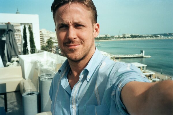 Actor Ryan Gasling on the background of the sea in summer