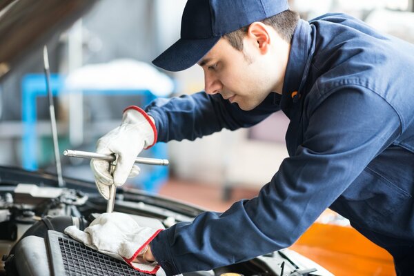 Der Mechaniker repariert das Auto professionell