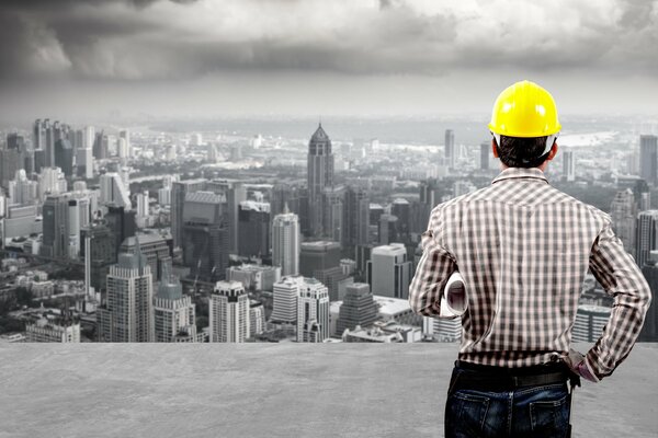 A man in a helmet looks at the city