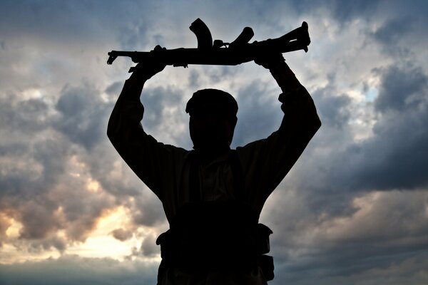 A man holds a gun in his hands