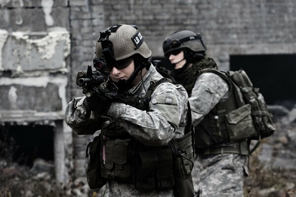 Soldiers with weapons in their hands take aim