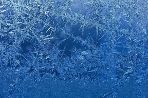 Blue frosty pattern on the glass