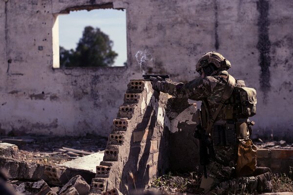 A soldier with a weapon defends himself in war