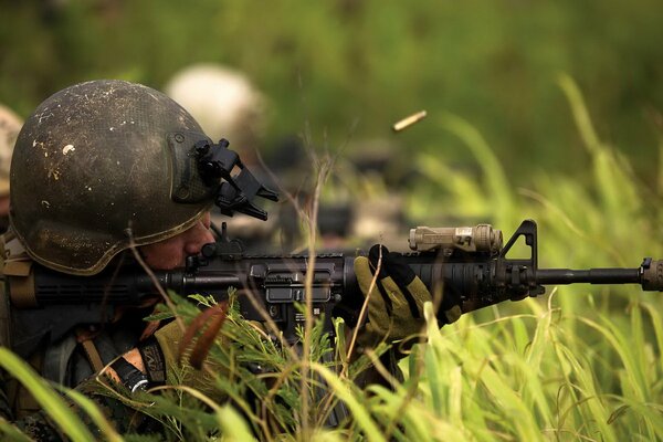 A soldier holds a weapon in his hands