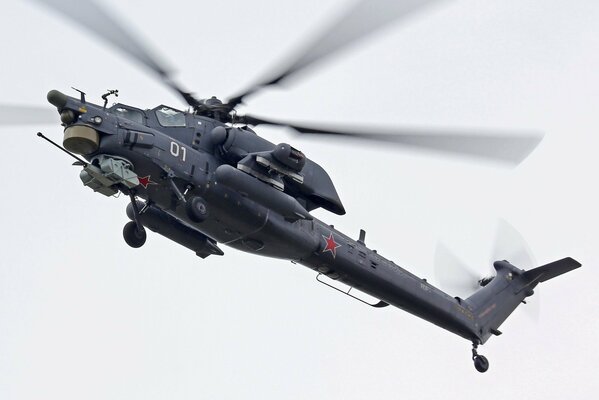 Russian Mi-28 helicopter with red stars in the sky