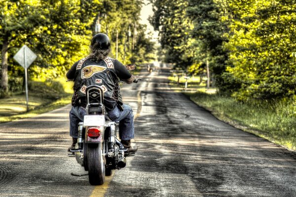 A biker rides a motorcycle on the road