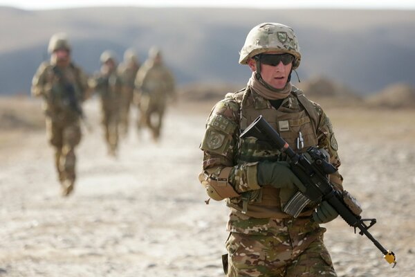 Soldiers with guns in the desert