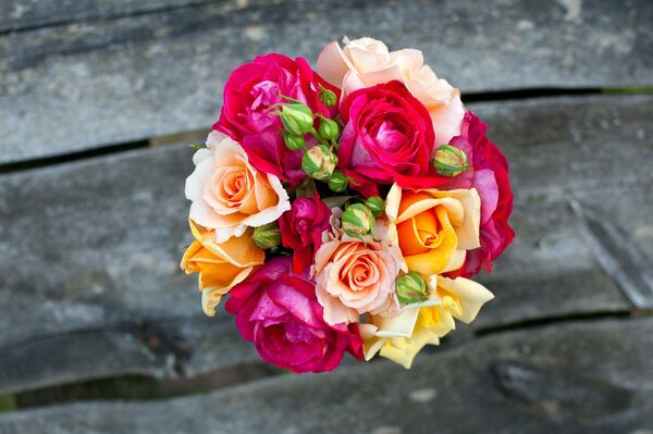 A multicolored bouquet on the boards lies beautifully