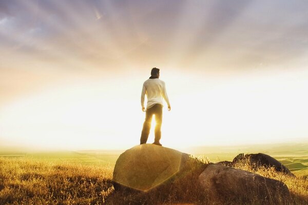 A man standing on a stone against the background of a rising soldier