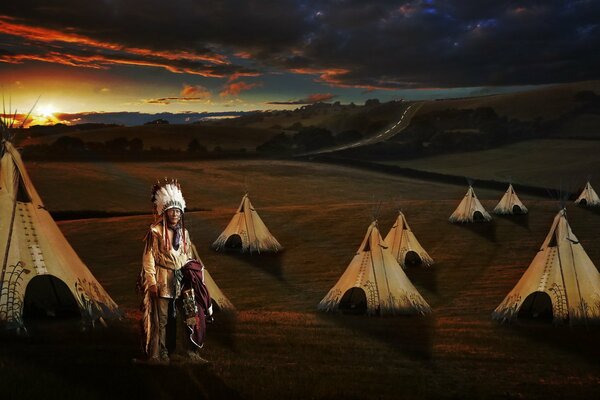 Indian and wigwams on the background of sunset