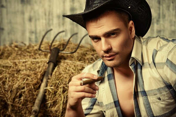 A cowboy in an unbuttoned shirt