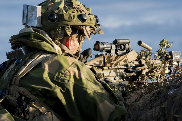 Photo of a soldier with a gun. Army