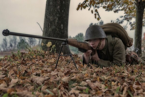 A soldier in a helmet with a gun