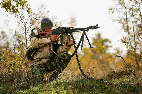 A sitting Bulgarian soldier with a gun