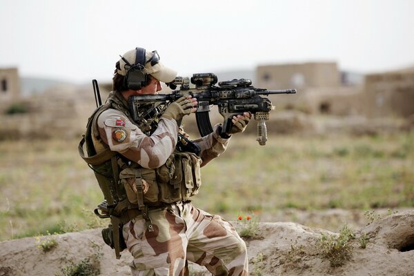 A soldier in the army, with a gun in his hands