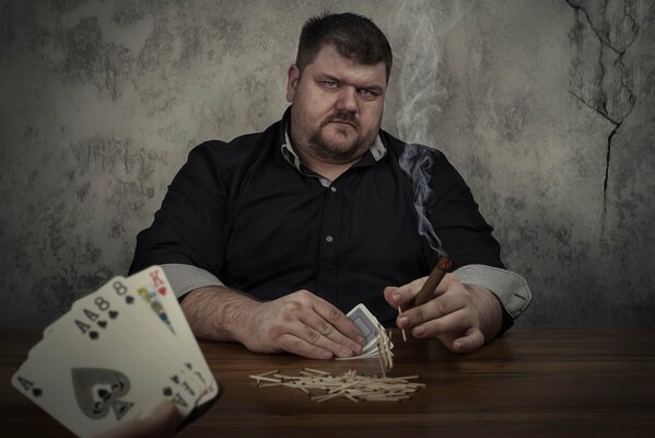 A poker game. A man with a cigar and cards