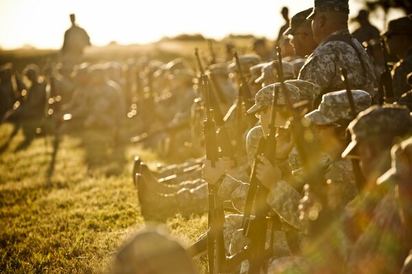 An army of soldiers with weapons in the sunlight