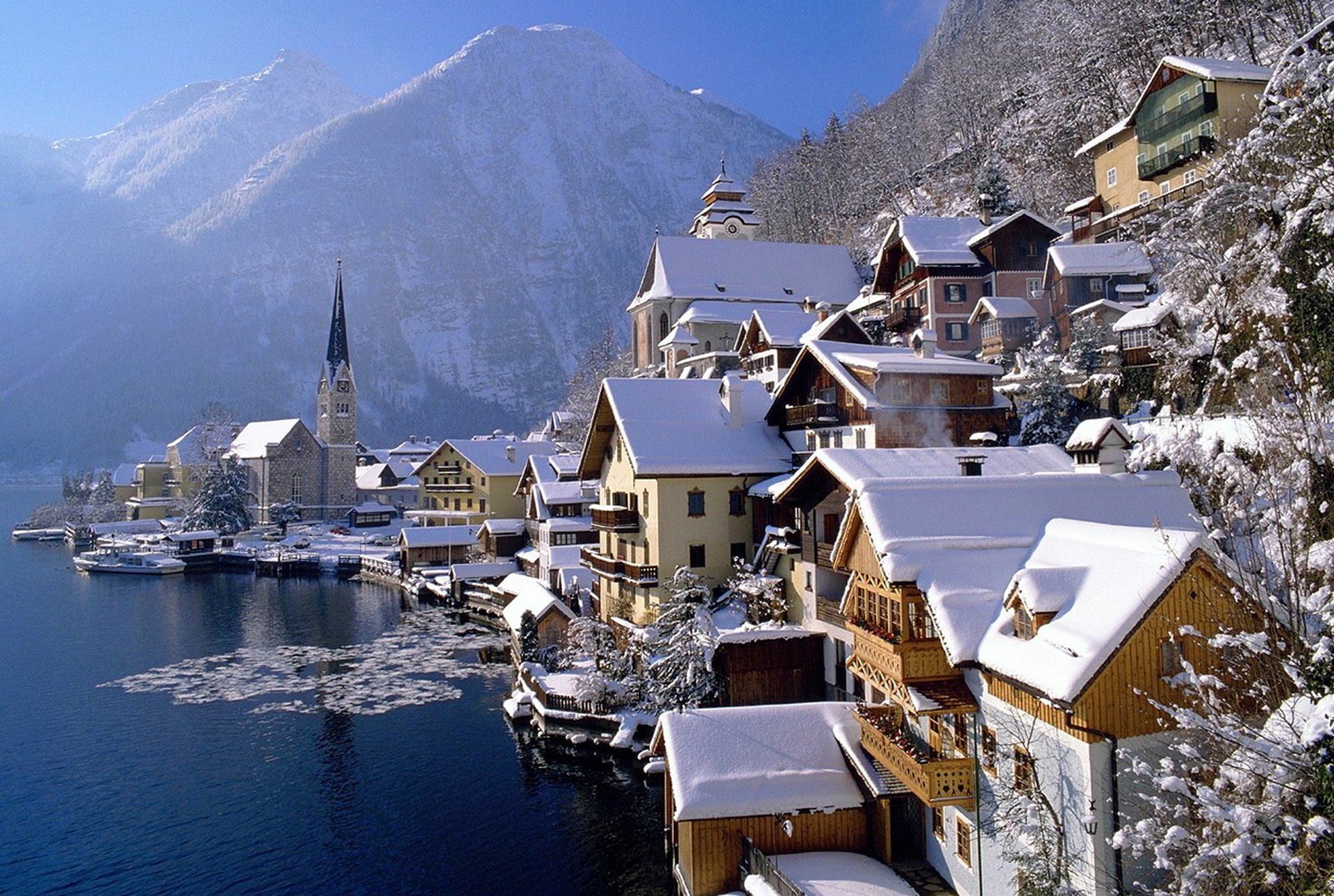 hallstatt lake hallstatt austria the city houses building lights reflection surface mountains the sky