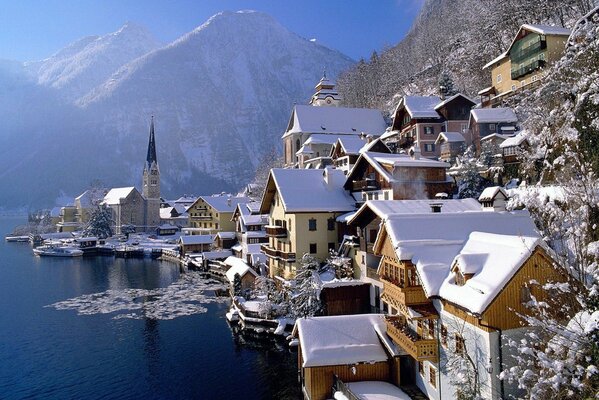 A city in Austria in the mountains is reflected in the surface of the lake