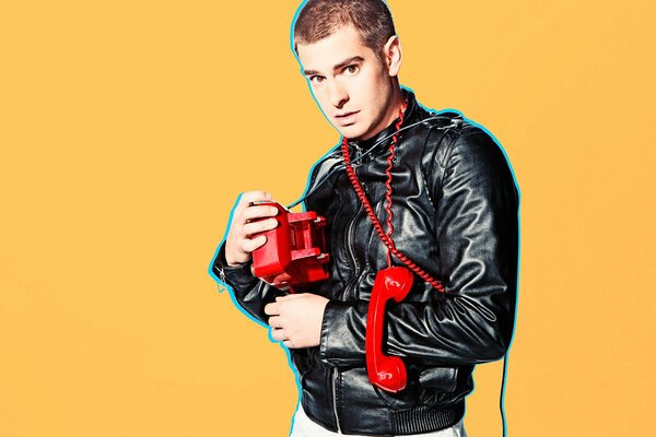 A bright photo of Andrew Garfield on an orange background